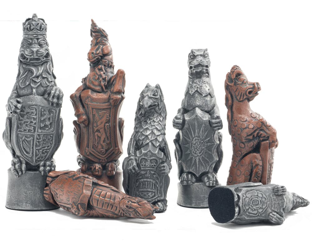 Royal Beast metal chess pieces with intricate designs and metallic finish, inspired by Hampton Court Palace Beasts, featuring felt bases.