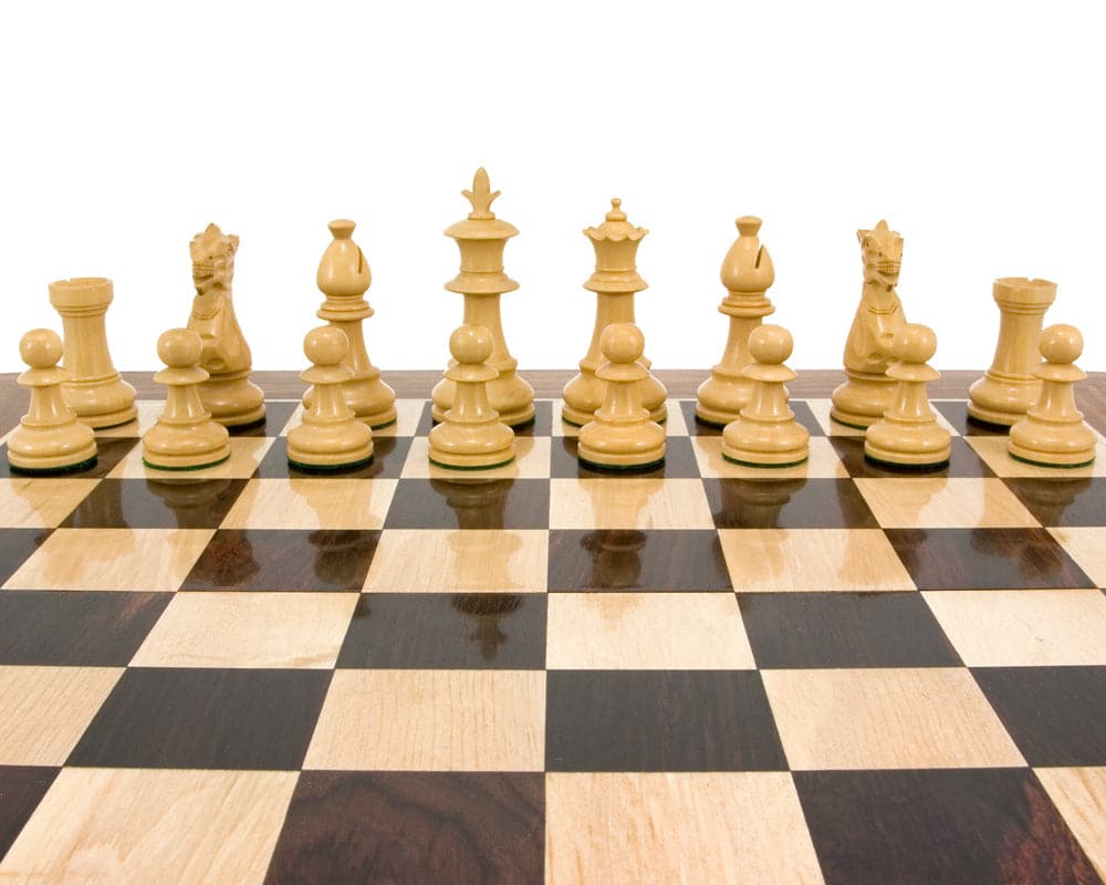 Ebonised Staunton chess pieces arranged on a wooden chessboard