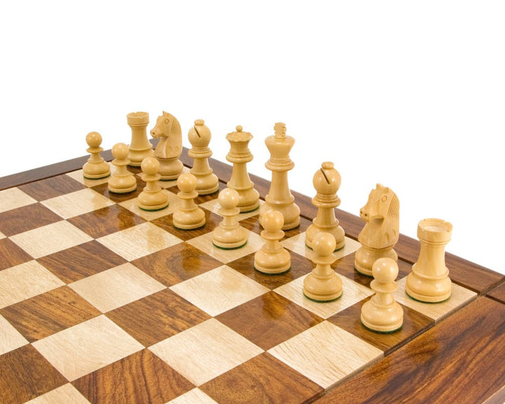 Down Head Knight Ebonised Staunton chess pieces set up on a wooden chessboard