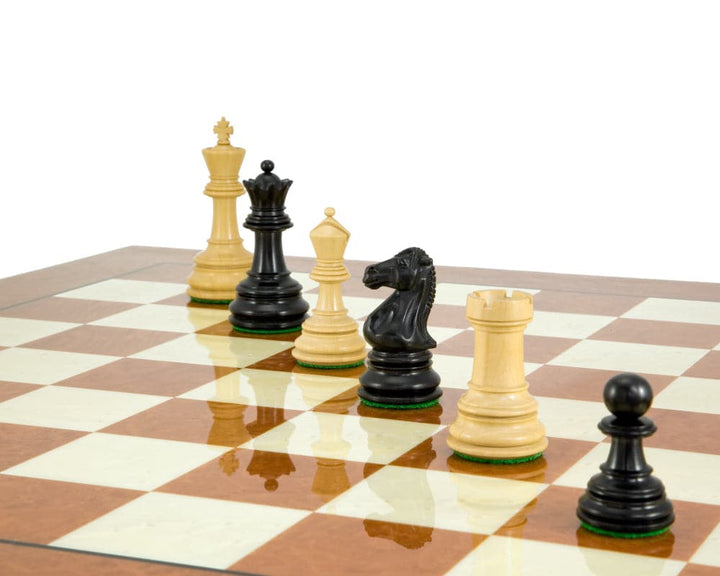 Cheltenham Series handcrafted ebony and boxwood chess pieces on a chessboard, featuring the 3.75 inch king and additional detailed queens