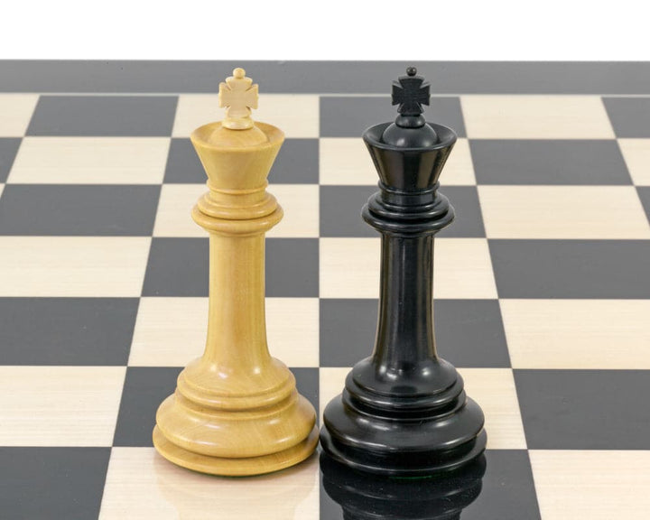 Parthenon Series Ebony and Boxwood chess kings on a chessboard, showcasing 4.5-inch ebony and boxwood craftsmanship.