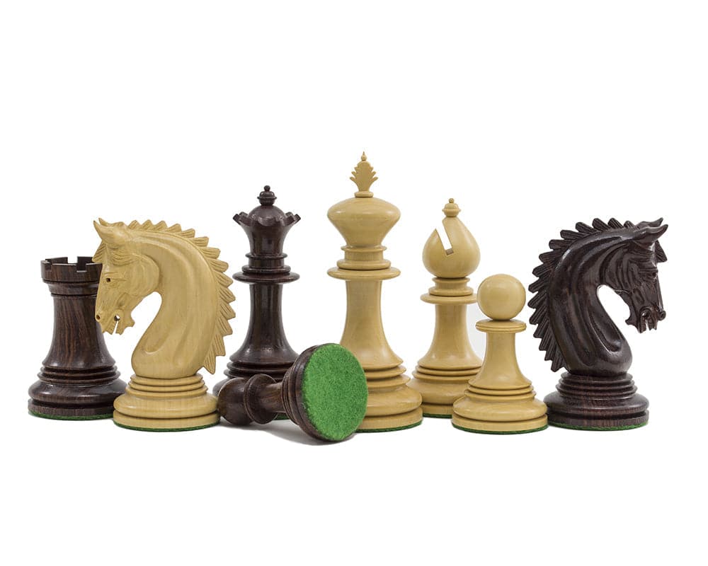 The Lemington Rosewood Chessmen 4.25 inch with ornately detailed pieces and a green billiard cloth-covered base.