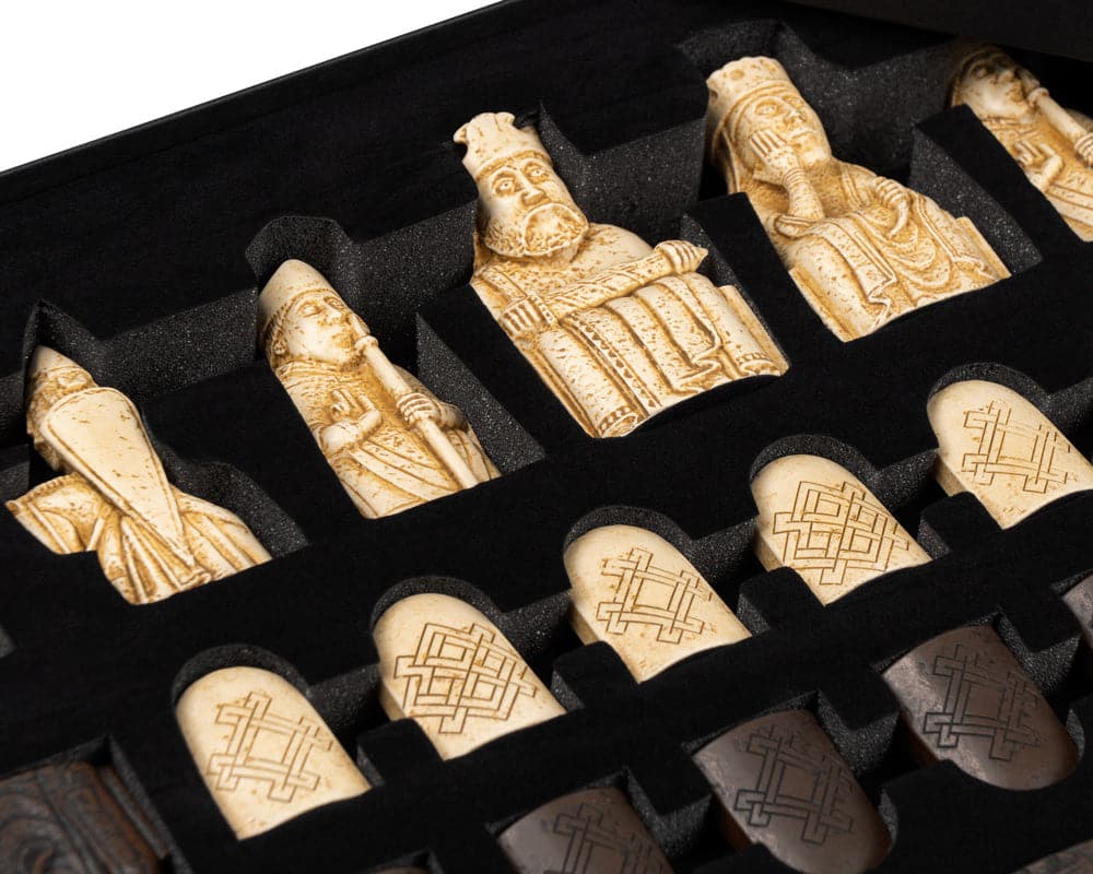 Lewis Chessmen set with intricately detailed pieces in gift packaging.