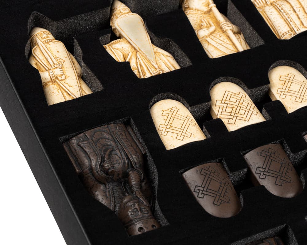 Lewis Chessmen set pieces in gift packaging, featuring intricate designs and craftsmanship, made in England.