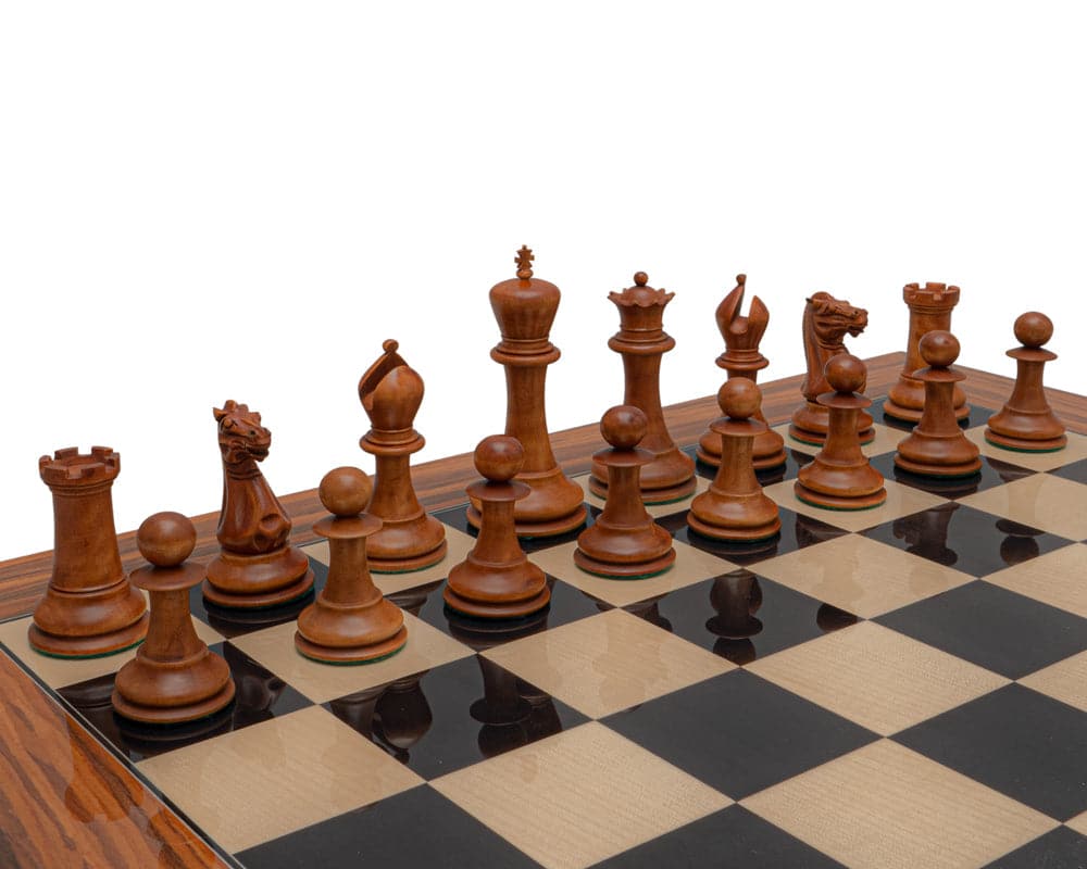 Reproduction Staunton Chessmen 1849 Model with 4.4 inch king in antiqued boxwood and ebony displayed on chessboard.