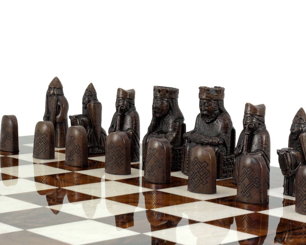 Isle of Lewis chessmen on Italian Briarwood chess board showcasing detailed craftsmanship and luxury design.