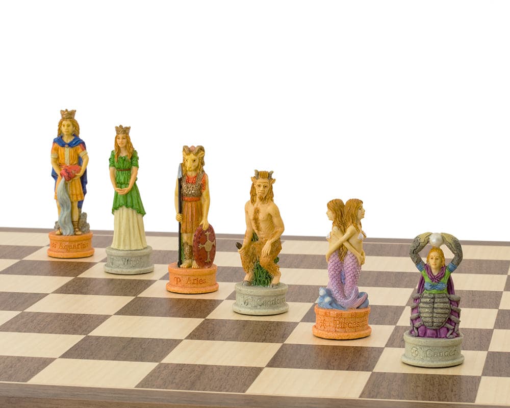 Hand-painted Zodiac-themed chess pieces on a walnut and maple chessboard featuring the 12 zodiac signs.