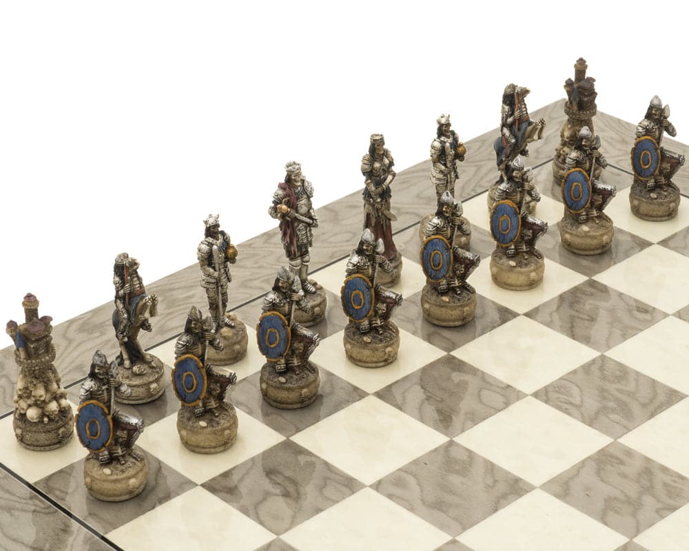 Hand-painted skeletal warrior chess pieces on a glossy grey ash burl board from The Zombie and Grey Ash Deluxe Chess Set.