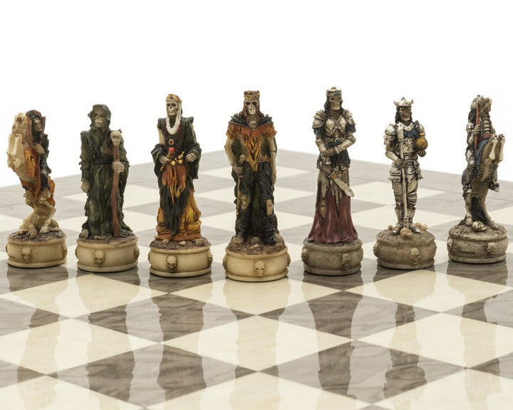 Hand-painted resin pieces from the Zombie and Grey Ash Deluxe Chess Set on a grey ash burl board.