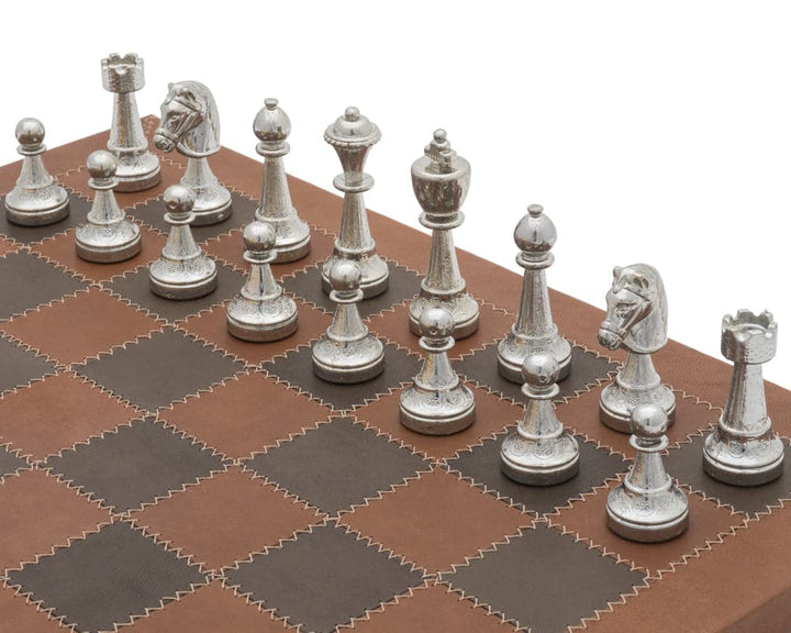 The Messina Gold and Silver Italian Leather Luxury Chess Set with metallic chessmen on a leather chess board