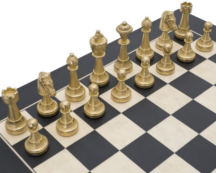 The Finnesburg and Black Classic Chess Set with brass chess pieces arranged on a black and white board.