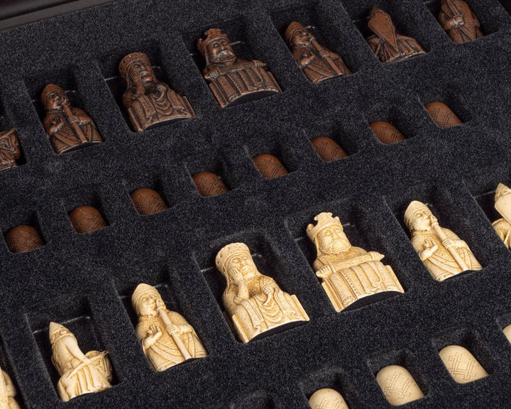 The Isle of Lewis chess pieces in a deluxe presentation box, showcasing detailed craftsmanship on a foam insert.