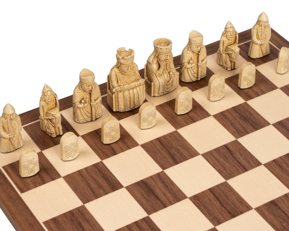 Isle of Lewis chess pieces on a Walnut Deluxe chess board with intricate carvings in an elegant presentation.