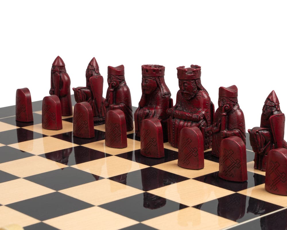 Isle of Lewis black and red chess set with intricately detailed pieces on a checkered board