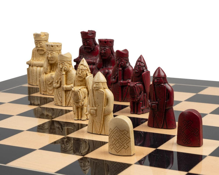 The Isle of Lewis black and red chess set with intricate pieces on a checkered board.