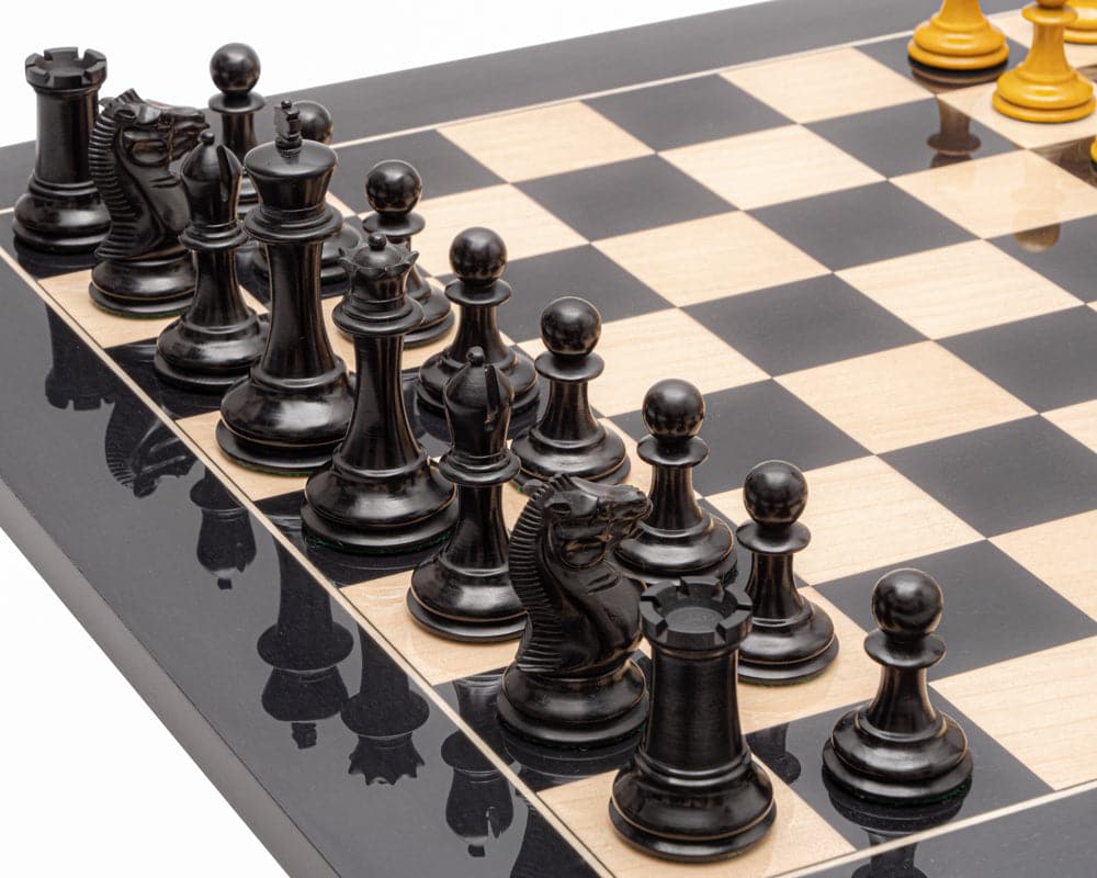 The Harrwitz Black and Anegre Staunton Chess Set on high gloss Black Anegre and Maple board in play, showcasing traditional hand-carved pieces.