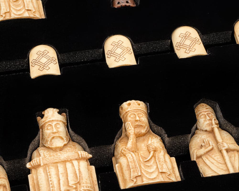 Isle of Lewis Chessmen in presentation case displaying exquisitely detailed chess pieces made from crushed stone resin.