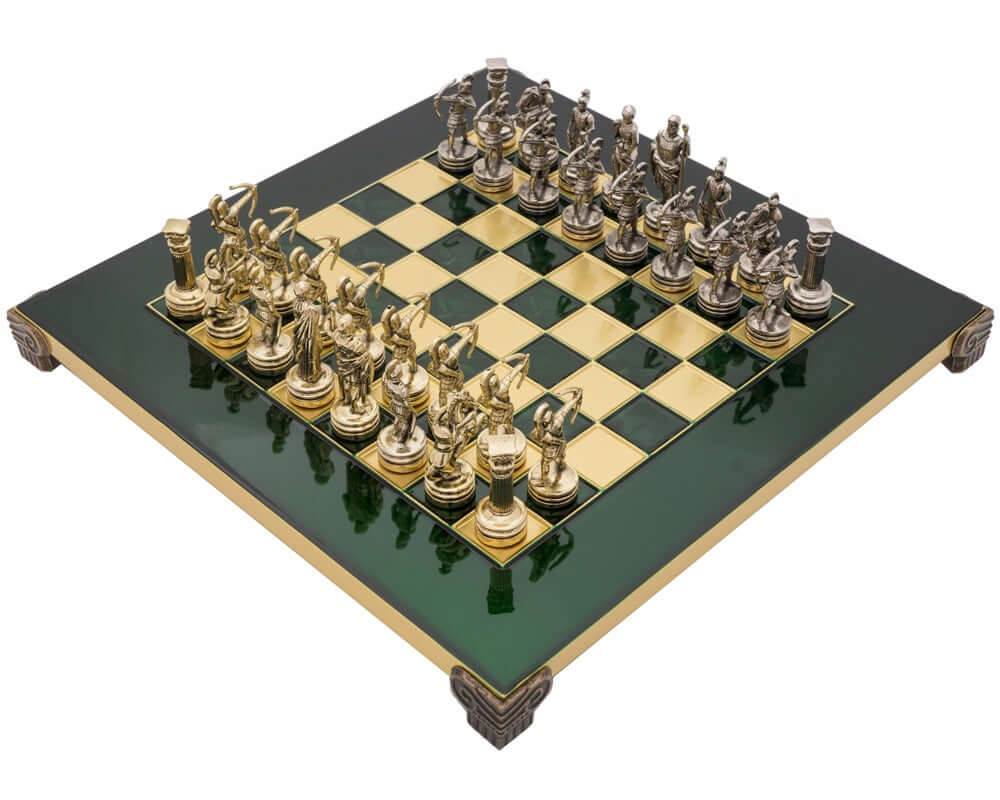 The Manopoulos Archers Chess Set with wooden case on green and gold chessboard, featuring intricately designed pieces.