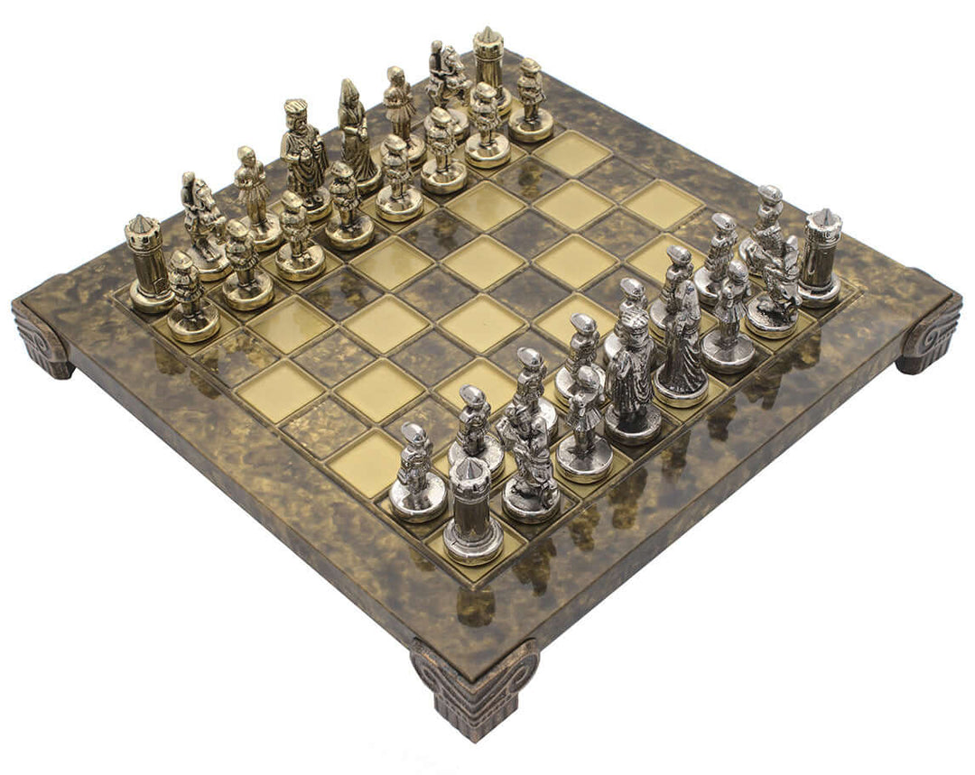 The Manopoulos Byzantine Empire Chess Set on brown wooden board with metal chess pieces in a compact design